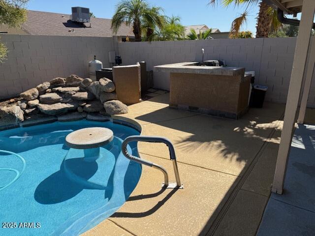 17371 N 86th Ave, Peoria, AZ 85382 - view of swimming pool with a fenced backyard, a patio area, an outdoor fire pit, and central AC unit