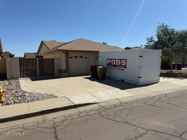 17371 N 86th Ave, Peoria, AZ 85382 - view of front of home with a garage, driveway, and a gate