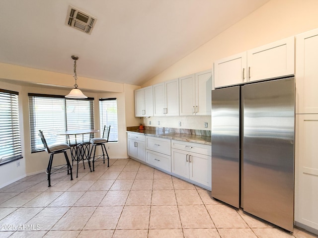 17371 N 86th Ave, Peoria, AZ 85382 - kitchen featuring stainless steel refrigerator, lofted ceiling, light tile patterned floors, white cabinetry, and pendant lighting