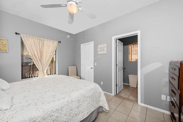 bedroom with ceiling fan, tile patterned floors, and ensuite bath