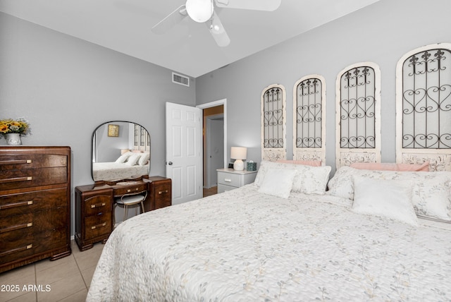 bedroom with ceiling fan and light tile patterned flooring