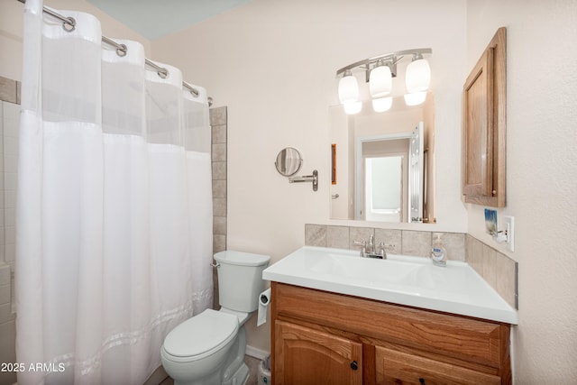 bathroom featuring toilet and vanity