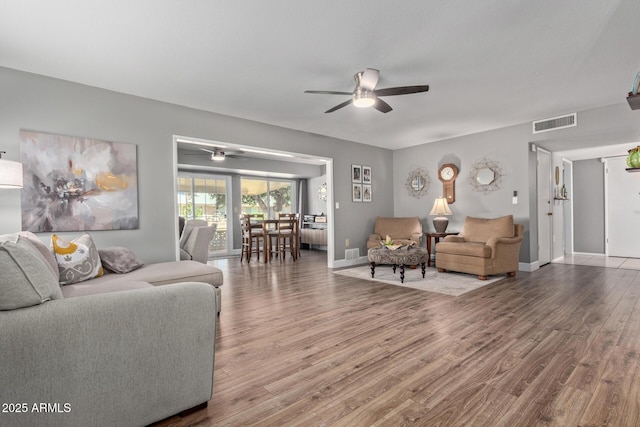 living room with ceiling fan and wood-type flooring