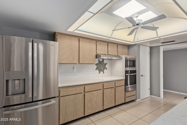 kitchen with decorative backsplash, light tile patterned floors, stainless steel appliances, and ceiling fan