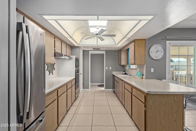 kitchen with sink, stainless steel appliances, backsplash, kitchen peninsula, and light tile patterned floors