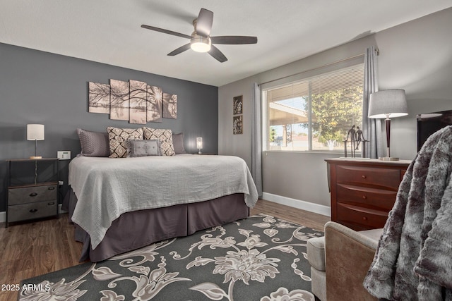 bedroom featuring ceiling fan and dark hardwood / wood-style floors