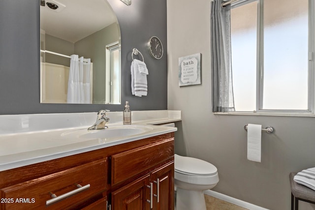 bathroom featuring a shower with shower curtain, vanity, toilet, and tile patterned flooring