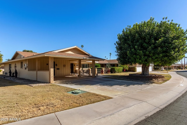 view of front facade with a carport and a front lawn