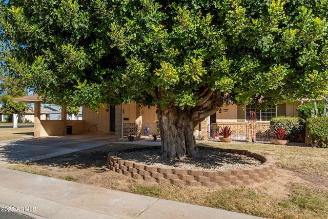 view of property hidden behind natural elements with a carport