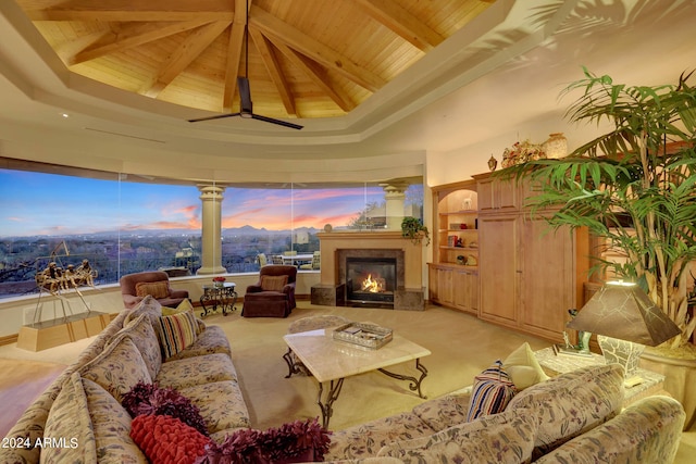 living room featuring beamed ceiling, ceiling fan, wooden ceiling, and light colored carpet