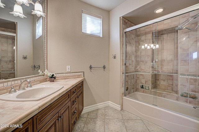 bathroom with enclosed tub / shower combo, vanity, and tile flooring