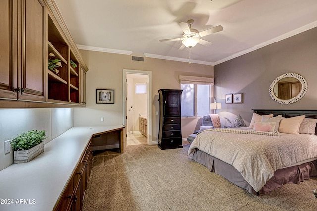 bedroom featuring ceiling fan, light colored carpet, ornamental molding, and ensuite bath