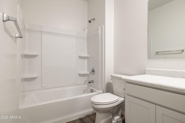 bathroom with toilet, bathtub / shower combination, wood finished floors, and vanity