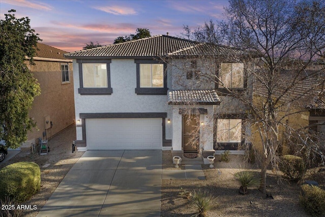 mediterranean / spanish-style home with a garage