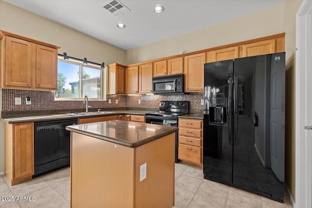 kitchen with tasteful backsplash, a kitchen island, sink, and black appliances