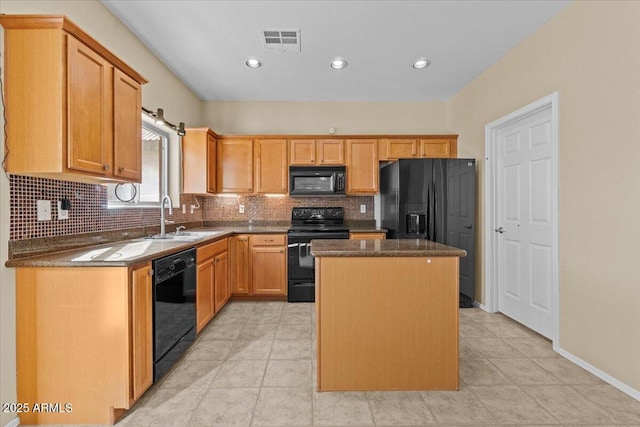 kitchen featuring sink, a center island, tasteful backsplash, black appliances, and light tile patterned flooring