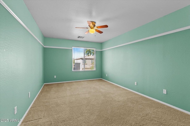 empty room with ceiling fan and carpet flooring