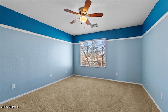 carpeted empty room featuring ceiling fan