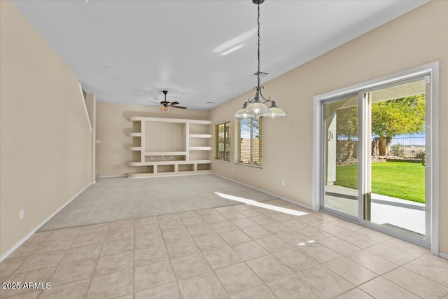 unfurnished living room featuring ceiling fan, built in features, and light colored carpet