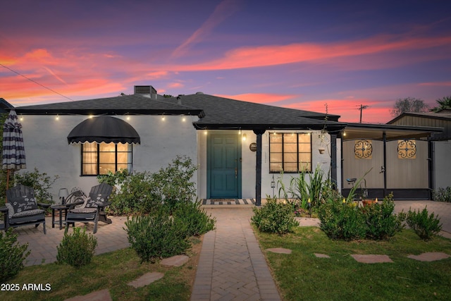 2041 N 16th Ave, Phoenix, AZ 85007 - view of front of home featuring stucco siding, a shingled roof, and a patio area