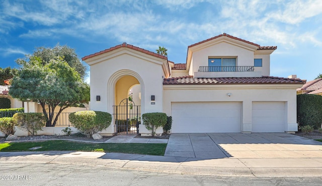 mediterranean / spanish-style house with concrete driveway, a balcony, a tile roof, an attached garage, and stucco siding