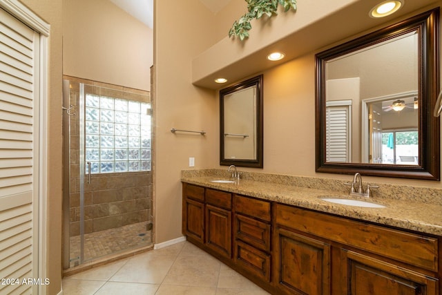 bathroom with tile patterned flooring, plenty of natural light, an enclosed shower, and vanity