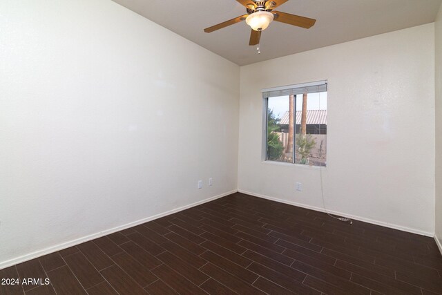 spare room featuring dark hardwood / wood-style flooring and ceiling fan