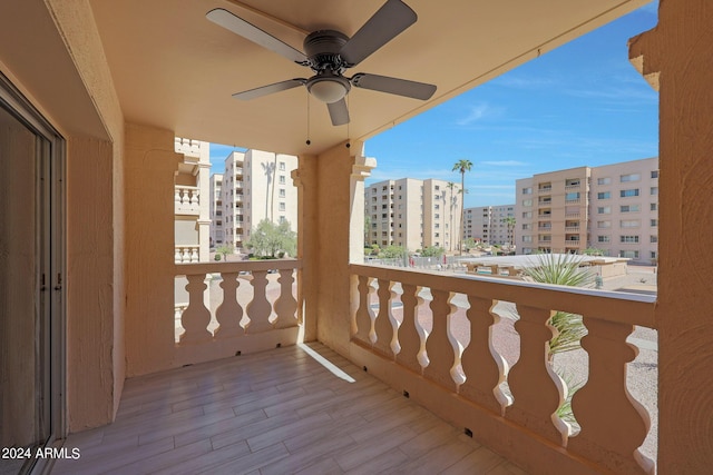 balcony featuring a ceiling fan and a view of city