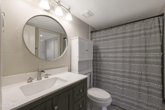 bathroom with toilet, visible vents, and vanity