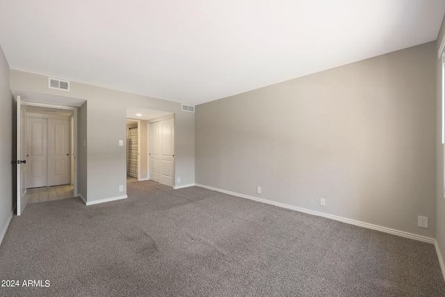 unfurnished bedroom featuring carpet floors, visible vents, and baseboards