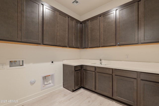 3483 W Sunstone Dr, San Tan Valley, AZ 85144 - washroom featuring hookup for a washing machine, cabinet space, light wood finished floors, baseboards, and hookup for an electric dryer