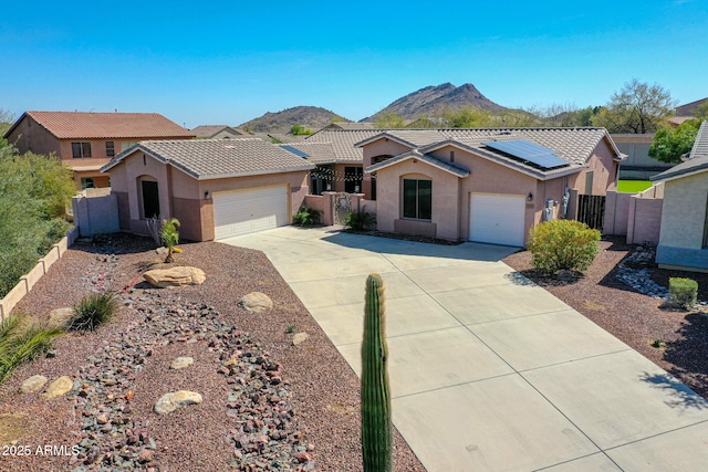 ranch-style house featuring a garage, fence, and stucco siding