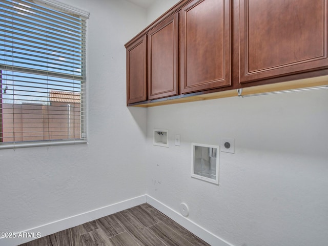 washroom with cabinet space, baseboards, gas dryer hookup, dark wood-style floors, and washer hookup