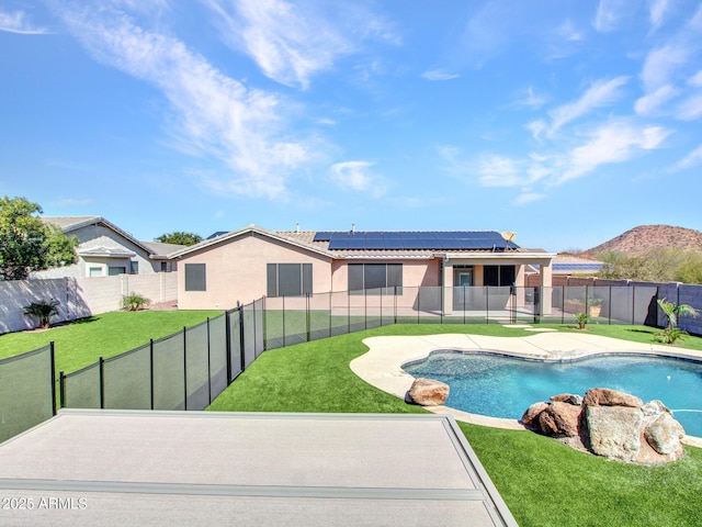 view of swimming pool featuring a fenced in pool, a patio area, a fenced backyard, and a yard