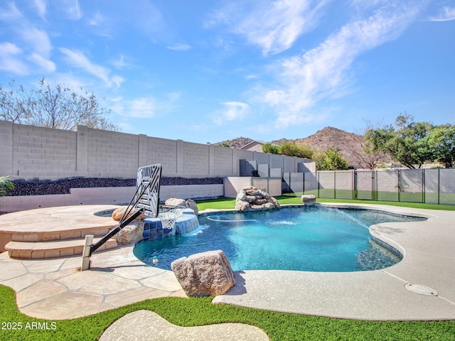 view of pool featuring a fenced in pool, a patio area, a fenced backyard, and an in ground hot tub