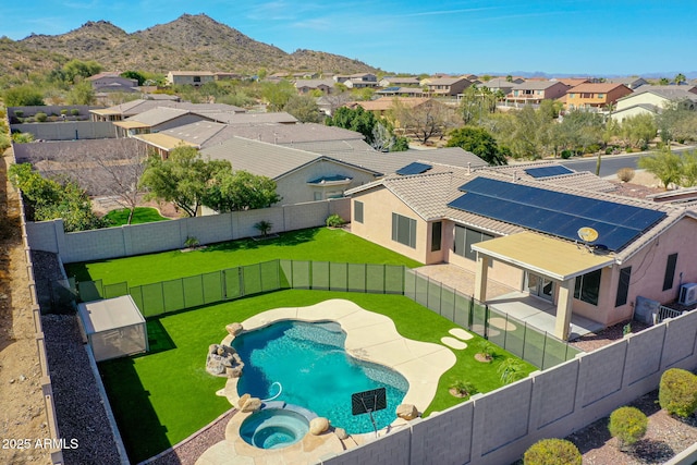 exterior space with a fenced backyard, a residential view, a mountain view, and a lawn