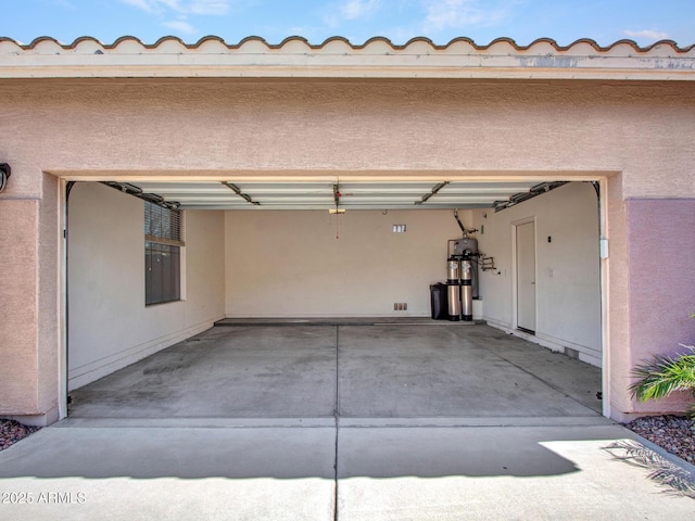 garage featuring concrete driveway