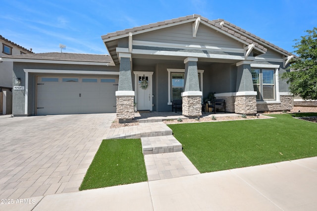 view of front of home with a front yard, stone siding, stucco siding, an attached garage, and driveway