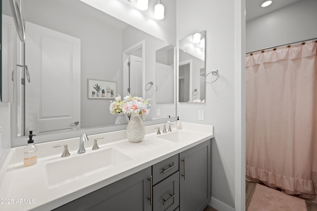 full bathroom with a sink and double vanity