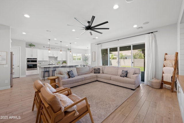living area with visible vents, a ceiling fan, light wood-style flooring, and recessed lighting