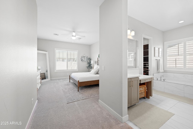 bedroom featuring baseboards, ensuite bathroom, and visible vents