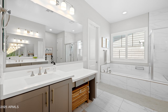 bathroom with visible vents, a shower stall, a bath, and vanity