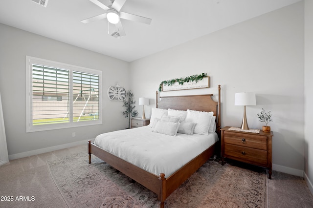 carpeted bedroom featuring baseboards, a ceiling fan, and visible vents