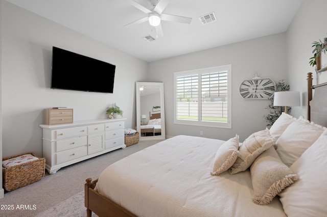 carpeted bedroom with ceiling fan and visible vents