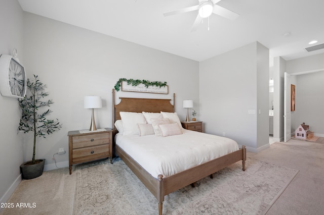 bedroom with baseboards, light carpet, and visible vents