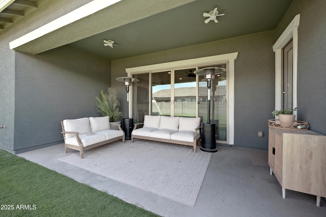view of patio / terrace with ceiling fan and an outdoor living space