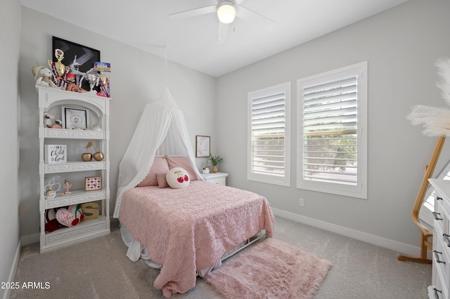 carpeted bedroom featuring baseboards and ceiling fan