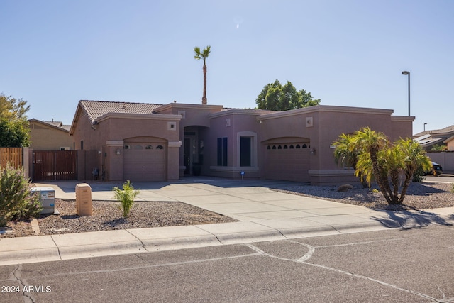 pueblo revival-style home with a garage