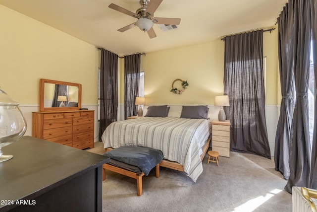 bedroom featuring ceiling fan and light colored carpet