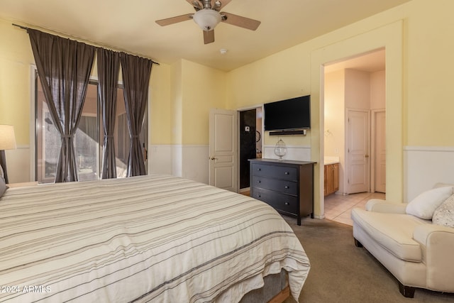 carpeted bedroom with connected bathroom and ceiling fan